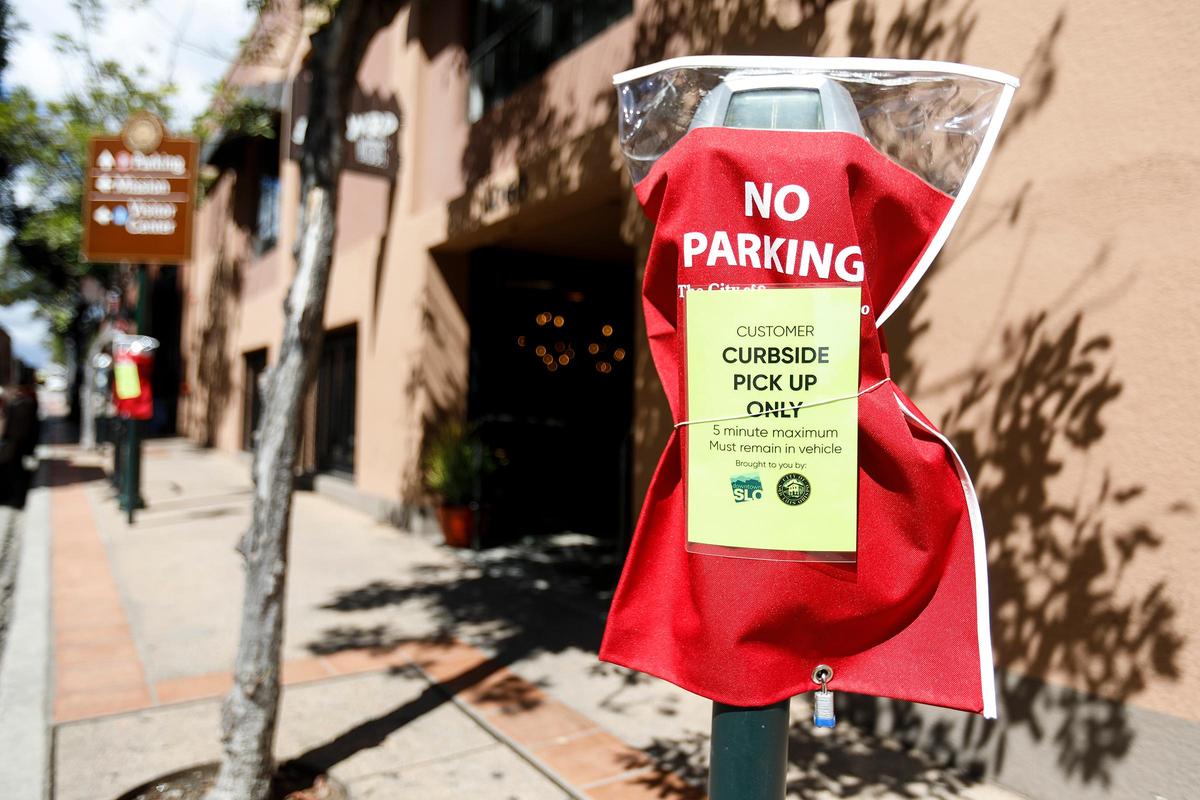 Parking meters are blocked off for restaurants providing take-out orders in downtown San Luis Obispo. These meters are in front Woodstock Pizza on Chorro Street.