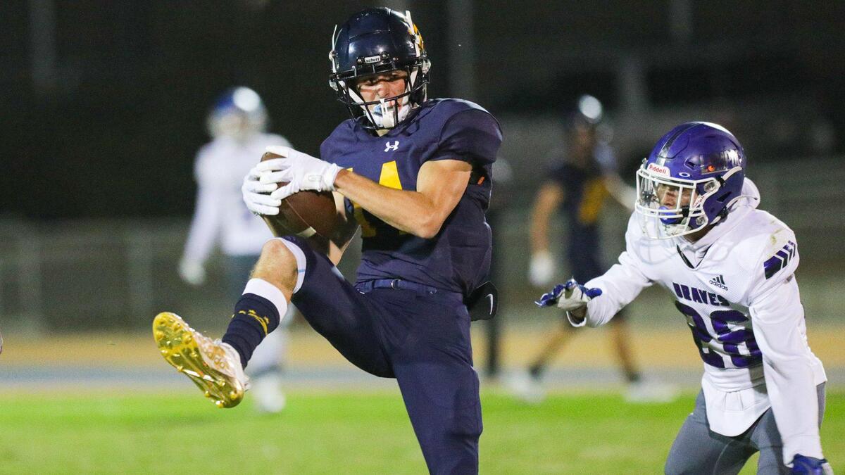 Bret Pinkerton makes a catch as Caden Boston defends. Arroyo Grande fell to Lompoc 42-37 in a hard-fought Mountain League football opener on Sept. 16, 2022.