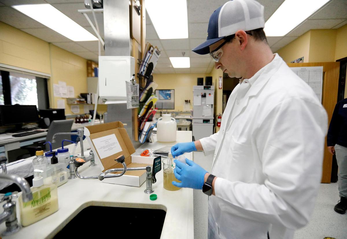 Tanner Duncan, a water quality lab analyst for the City of San Luis Obispo, preps a sample of wastewater to be sent out for testing. The SLO County Public Health Department uses wastewater surveillance to monitor COVID prevalence here.