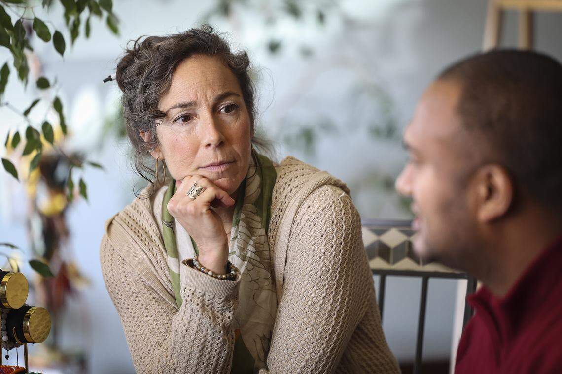 Franca Gentile Lansky, Life & Health coach and bodyworker at Healing Tree in Atascadero listens to Ven. Lobsang explain the details of the Mandala.  Buddhist monks from Tibet were in Atascadero creating a Medicine Buddah Sand Mandala, with the intention to distribute healing energy to all sentient beings and eliminate suffering on Oct. 23, 2025.
