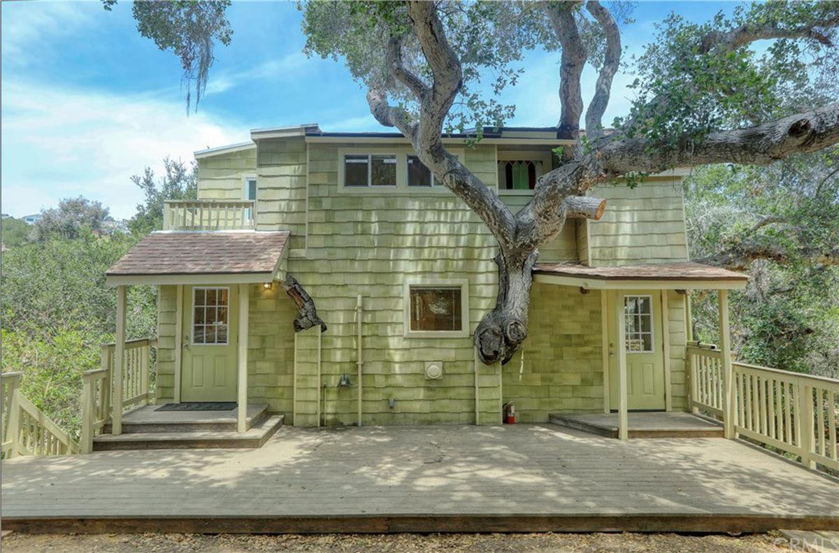 A dwelling at 765 Price Canyon Way in Pismo Beach, California is built around a real Coastal Oak Tree.