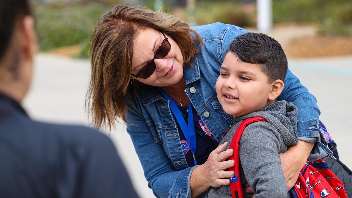 Aid Jodie Patton had hugs for the kids that ran up to her with arms out including Iker Chavez, 6. Students returned for the school year at Cambria Grammar School Aug 16, 2022.
