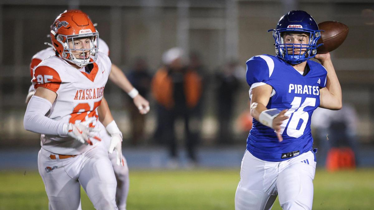 Cole Loney pursues quarterback Sands Dougherty. Morro Bay beat Atascadero 42-14 in a high school football playoff game on Nov. 15, 2024.
