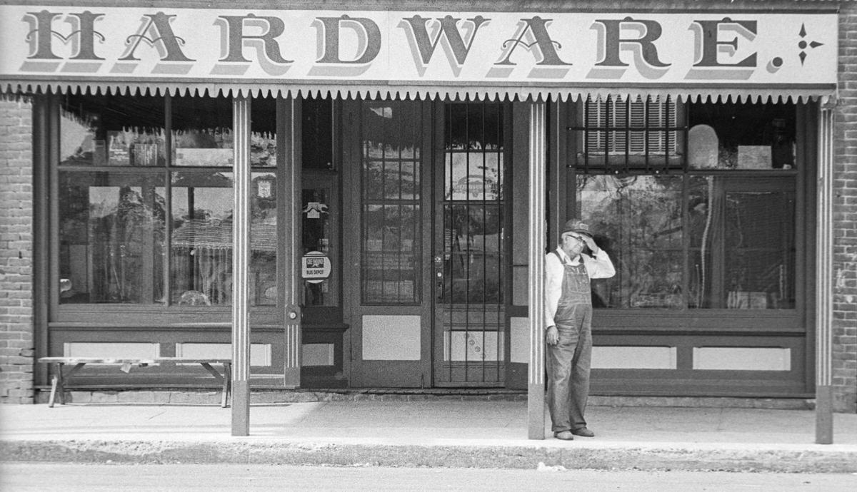 From outside Hewitt’s Hardware across the street, a man watches as work began to restore the fire-damaged landmark Templeton Feed & Grain on Oct 4, 1979, following a fire on Aug. 24 of that year.