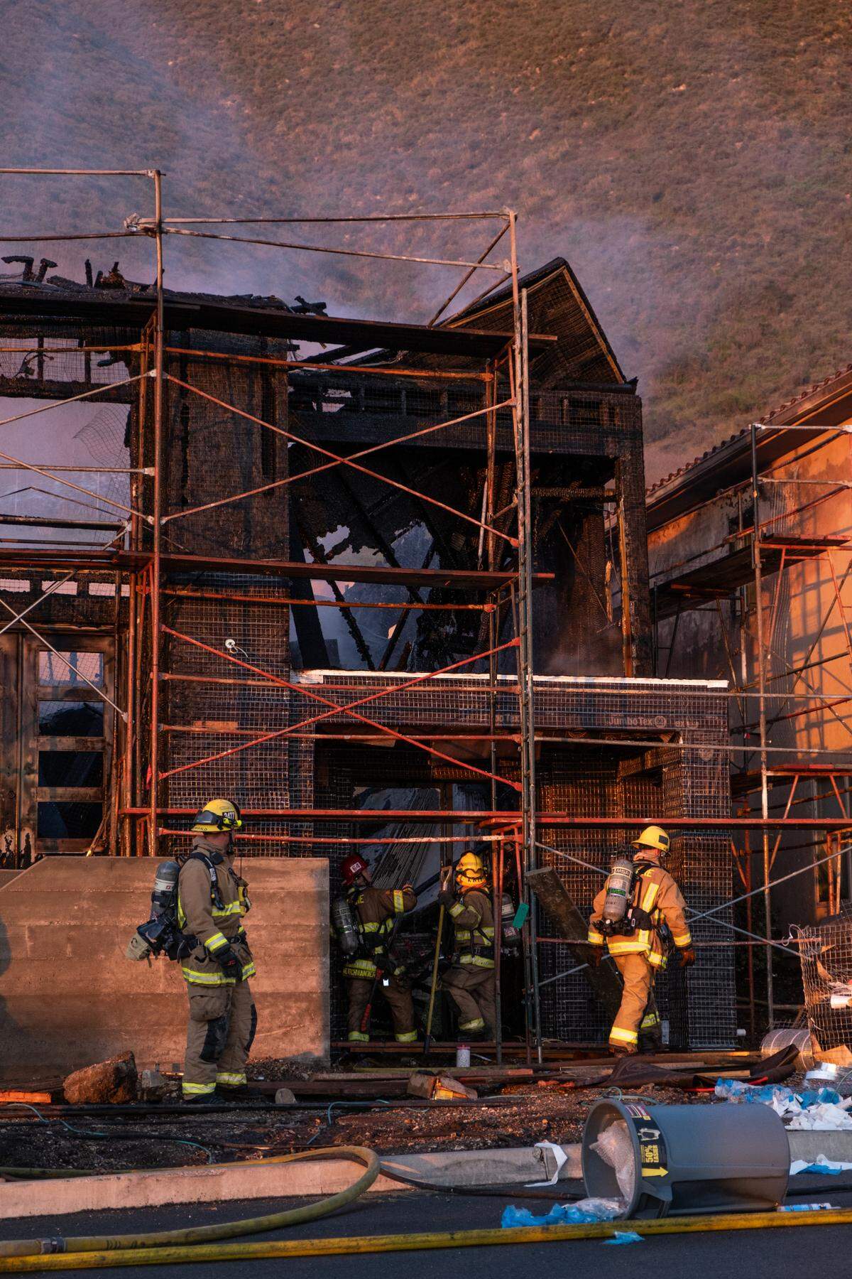 Firefighters work to extinguish a fire Tuesday afternoon at a new home under construction in the 1200 block of Costa Brava in Pismo Beach.