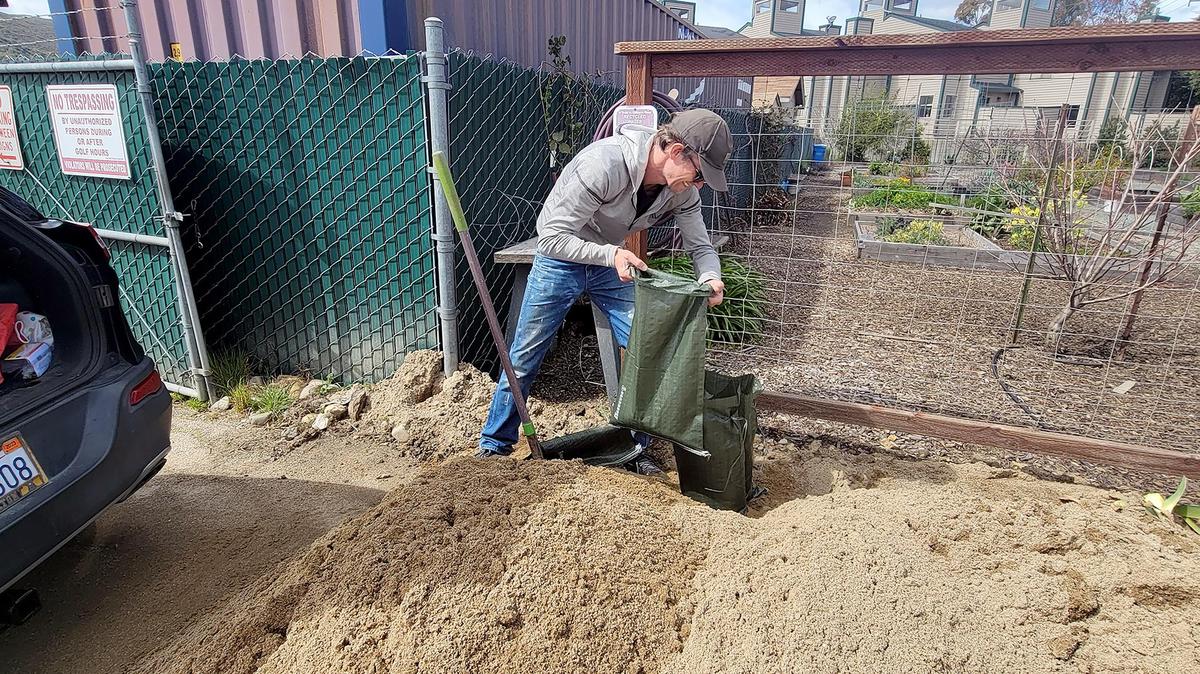 Richard, who only wanted to go by his first name, fills sandbags in the parking lot at the Laguna Lake Golf Course in San Luis Obispo on Wednesday, March 8, 2023.