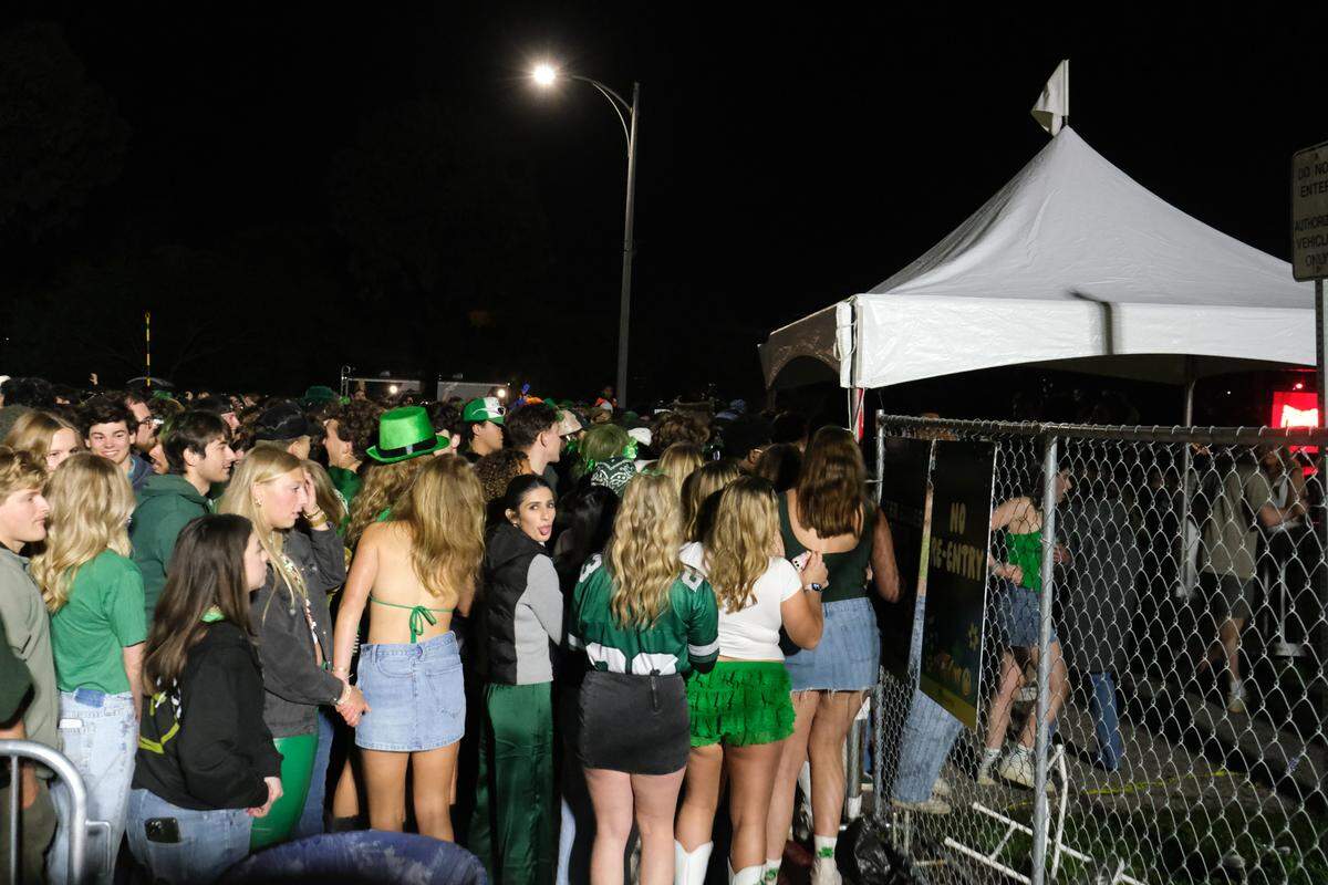 Cal Poly students rush the security and barricades into Cal Poly’s “Morning on the Green” music festival on March 15, 2025.