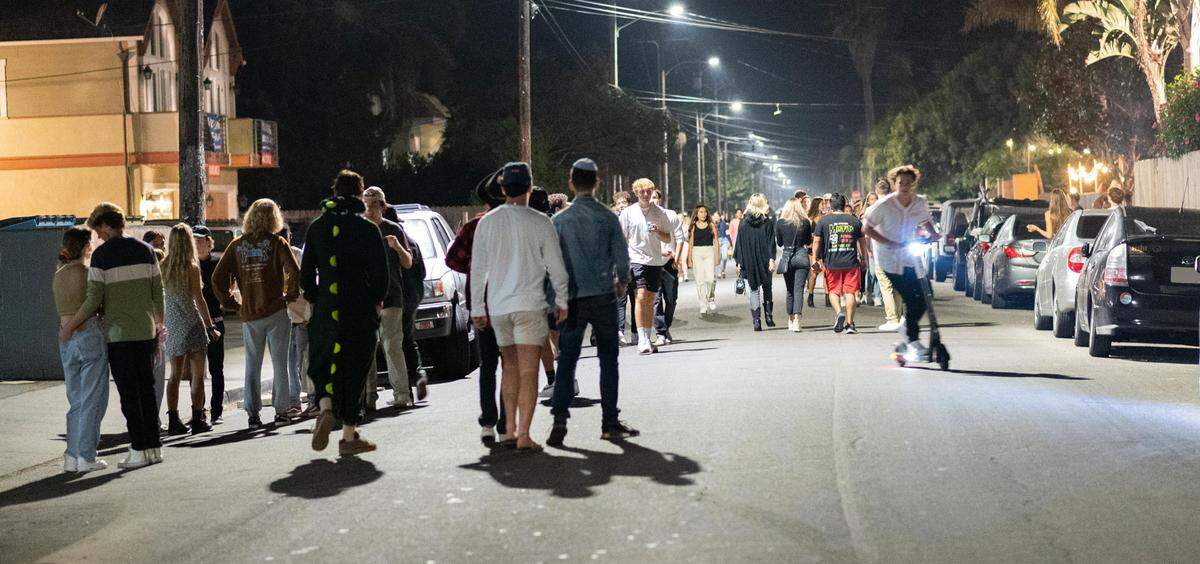 Although not as crowded as in the past, the streets of Isla Vista draws students out at the end of October 2020.
