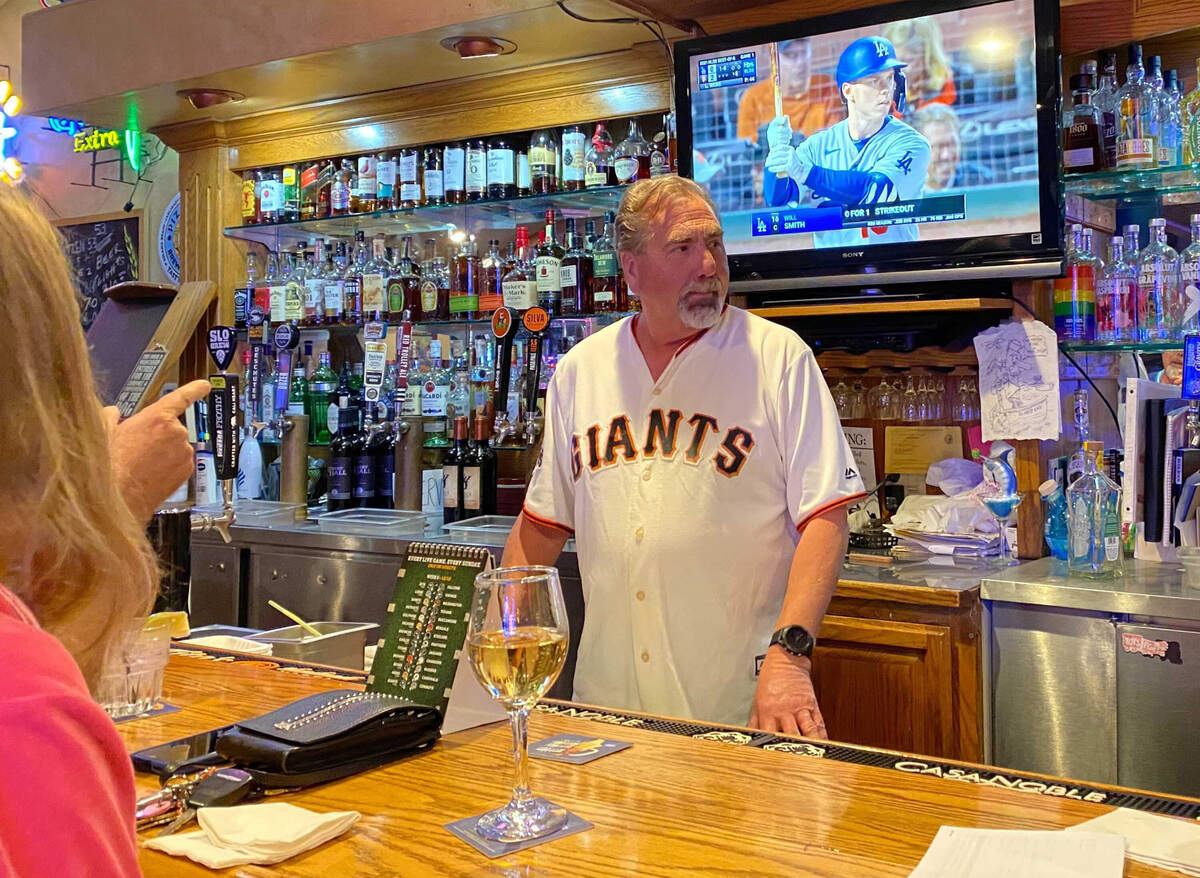 Gary Neal, co-owner of West End Bar & Grill in Cambria, California, watches his San Francisco Giants beat the Los Angeles Dodgers Friday night, Oct. 8, 2021. Saturday was a different story. (Maria L. La Ganga/Los Angeles Times/TNS)