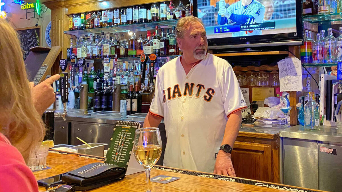 Gary Neal, co-owner of West End Bar & Grill in Cambria, California, watches his San Francisco Giants beat the Los Angeles Dodgers Friday night, Oct. 8, 2021. Saturday was a different story. (Maria L. La Ganga/Los Angeles Times/TNS)