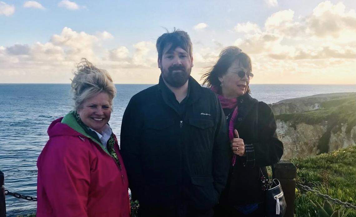 Chris Lambert, center, with Denise Smart, right, and another member of the Jam Fam on Feb. 20, 2019, at the bench at Margo Dodd Park in Shell Beach.