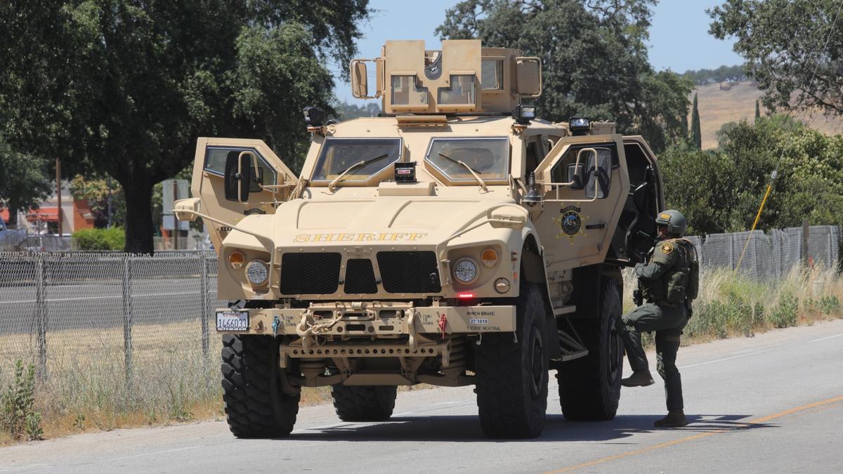 An officer who was reportedly shot at the scene was brought into an Armored Bearcat to be transported.