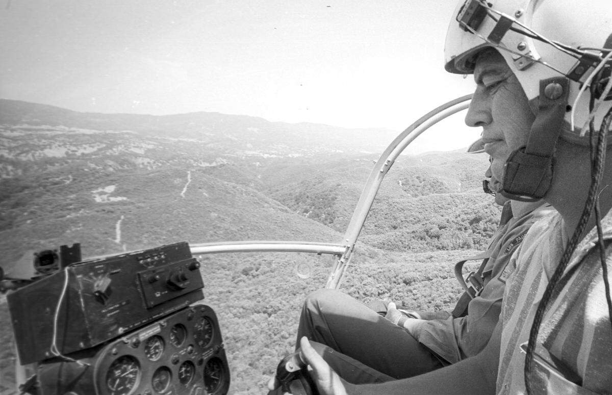 Pilot Bob Greehaw flys a firefighting helicopter near Pozo as a Helitack crew trained near Pozo on July 17, 1967.