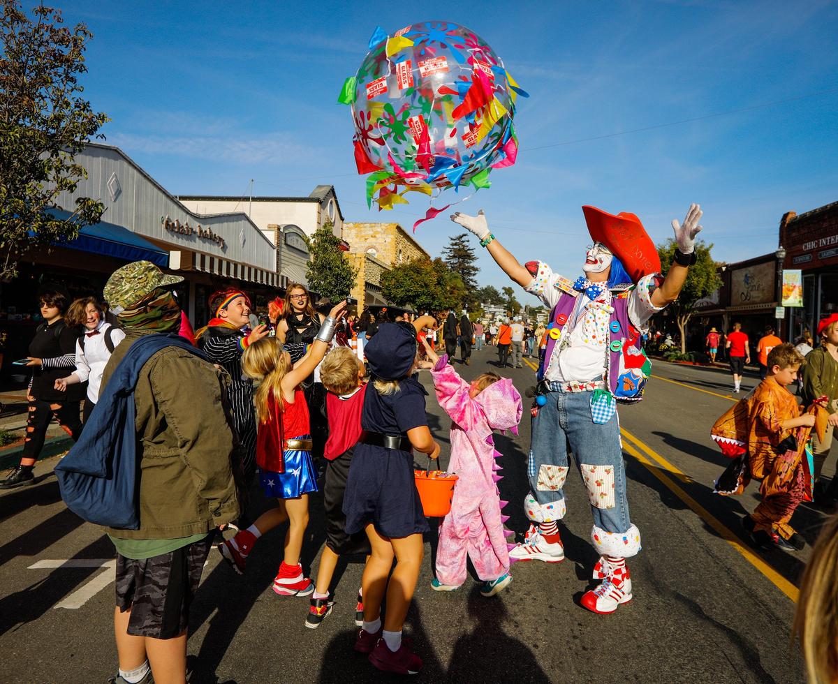 Balloony the Clown plays with trick-or-treaters during the Halloween in the Village event in Arroyo Grande in 2018.