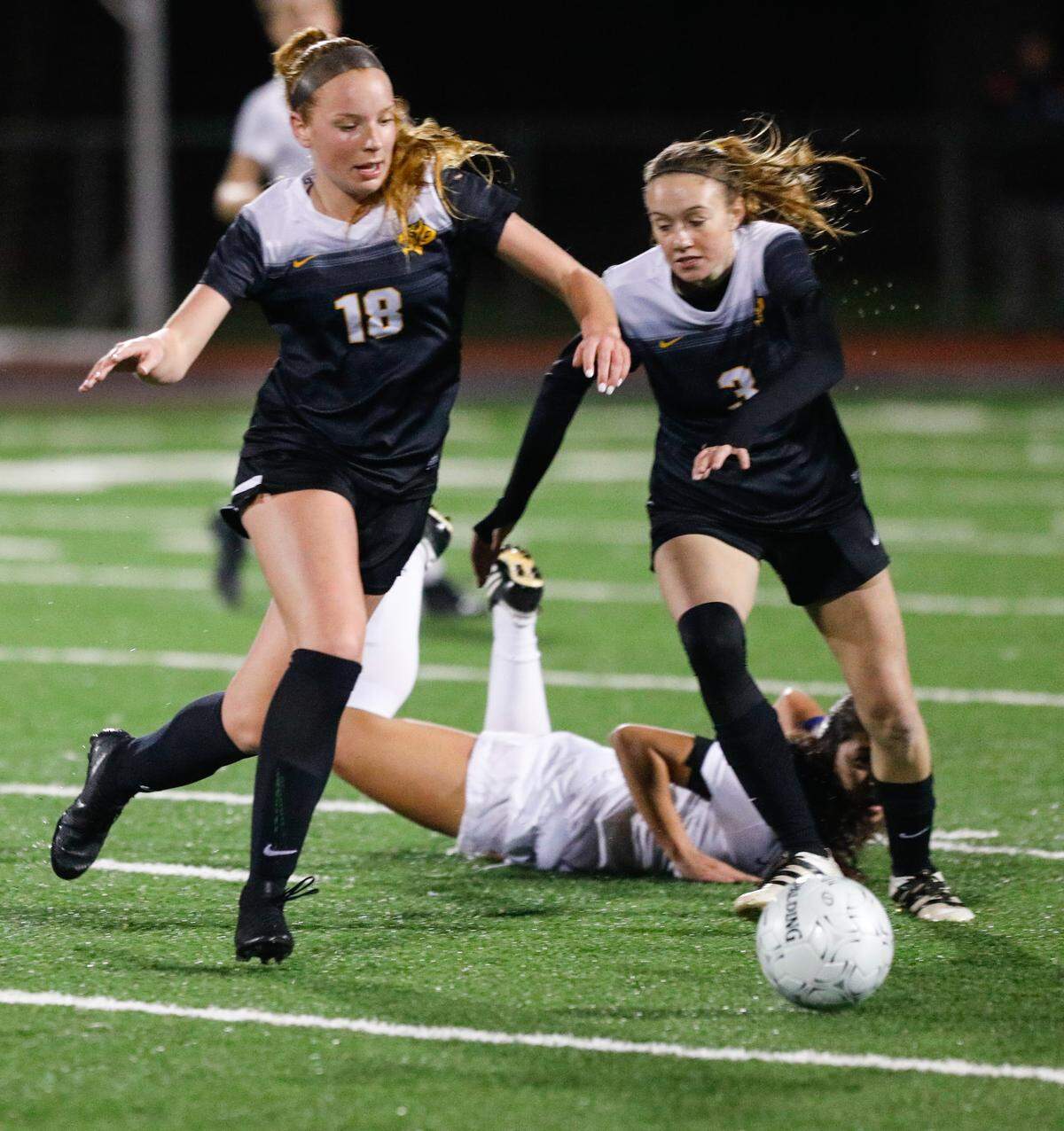 Molly Massman, left, competes in a San Luis Obispo High School soccer match in February 2019.