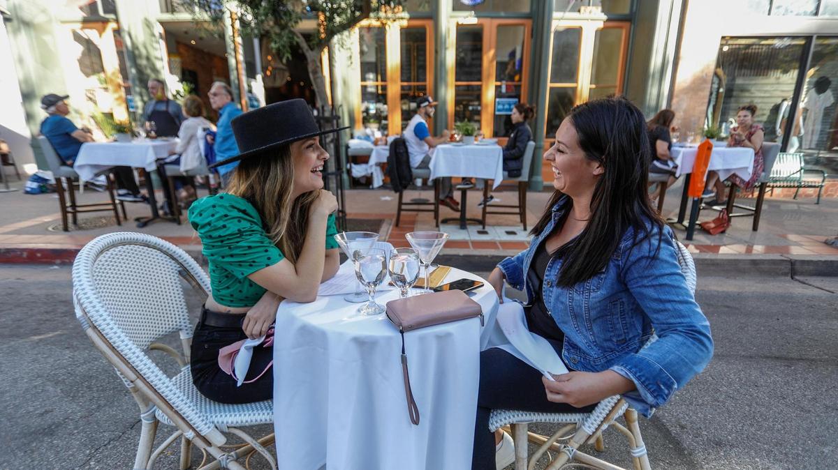 Two friends, Savannah Starr, left, San Luis Obispo and Brooke Smith, Templeton, enjoy street dining in front of Giuseppe’s in San Luis Obispo.