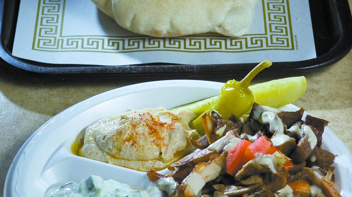 The lamb-chicken gyro plate includes fresh-baked pita bread, hummus and cucumber yogurt salad.