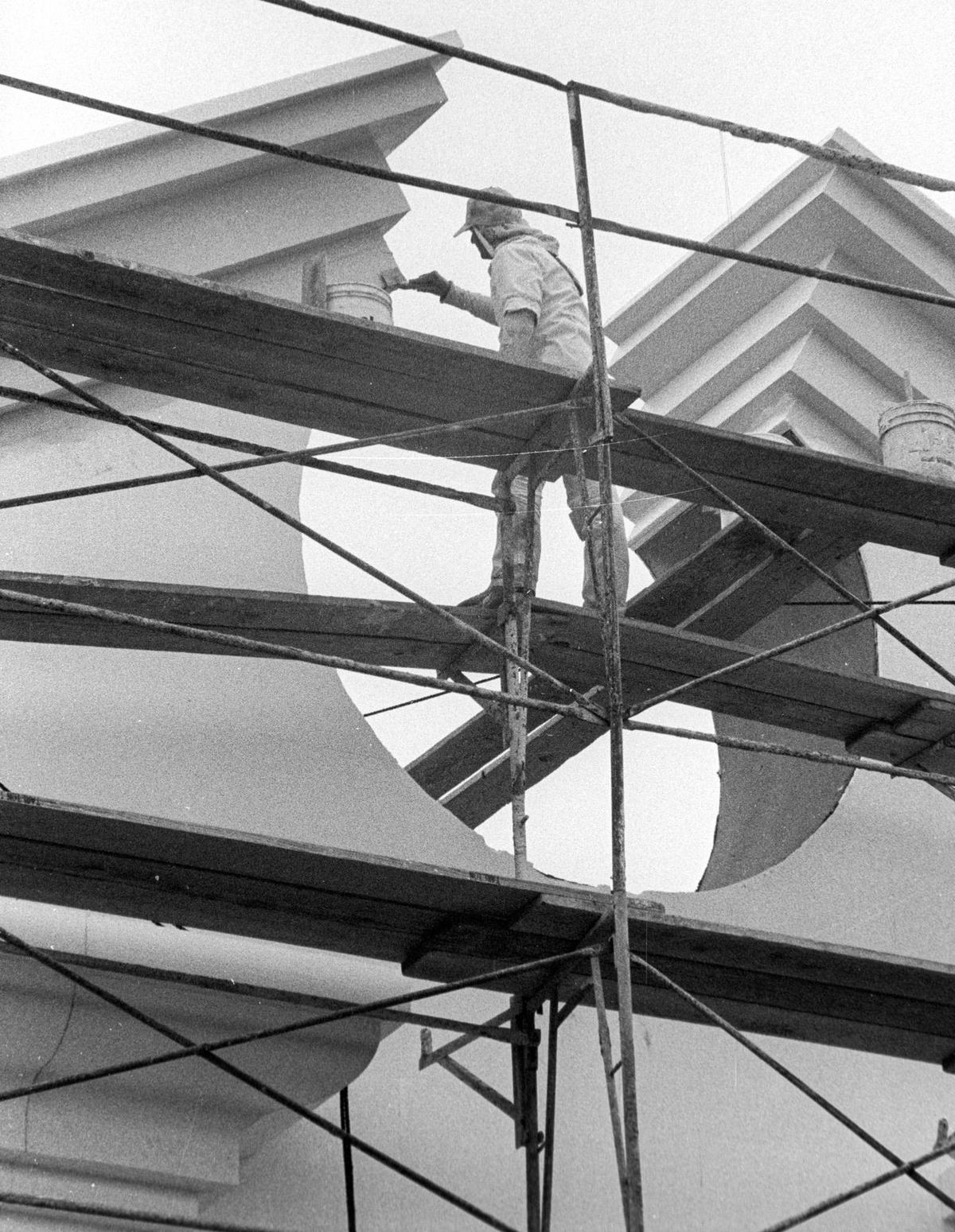 Alan Russ plasters the top of the former J.C. Penney building in downtown San Luis Obispo, seen from Higuera St. Ross Stores Inc. has taken over the building, and its Dress for Less store’s grand opening is slated for July 1991. This photo is from June 12, 1991.