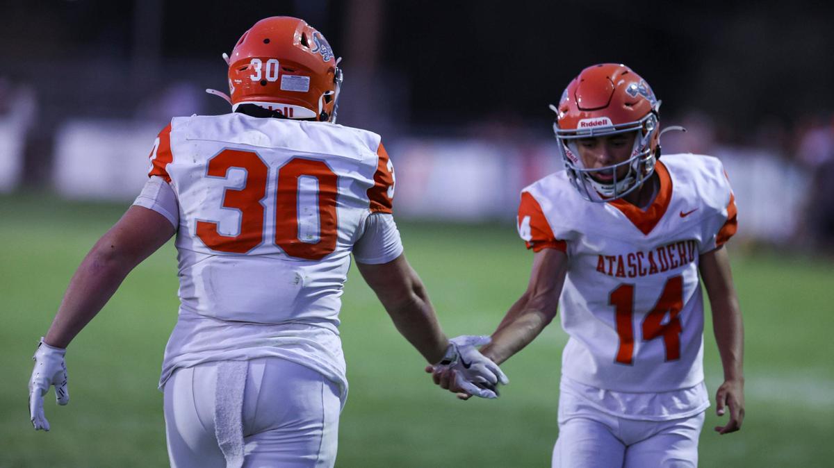 Austin Smith is congratulated by Michael Trejo after he took a handoff into the end zone for a touchdown. Atascadero beat Templeton 10-7 on a field goal with less than two seconds on the clock in a high school football game on Sept. 27, 2024.