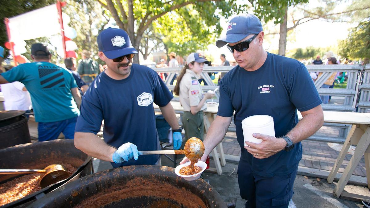 Paso Robles City firefighters helped stir and serves beans for the annual Pioneer Day Bean Feed. On hand Saturday, Oct. 8, 2022, were Daniel Burgess, left, and Doug Harris from Paso Robles City Fire Station One.