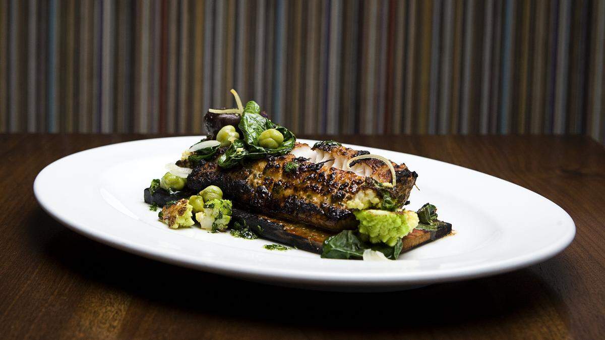 Chef Chris Kobayashi of Artisan prepares his cedar-planked sablefish with romanesco, crushed potatoes and a Moroccan spice mixture called chermoula.
