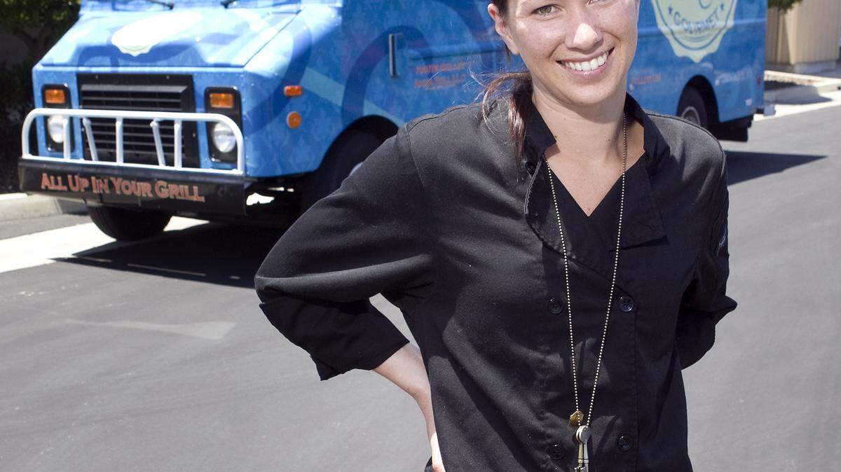 Anna Andriese, owner of Haute Skillet, poses in front of her food truck.