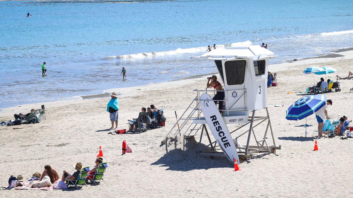 Lifeguard Delci Sawyer keeps a watchful eye on holiday crowd at the Olde Port Beach near Avila Beach on July 1, 2024.