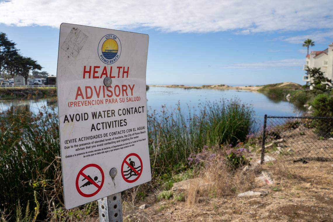 A city health advisory warns visitors against swimming or contacting the water of Pismo Creek, pictured here on Wednesday, Oct. 15, 2025. Members of the Blue Water Task Force are sounding the alarm about the amount of pollutants in the creek's flow, which they say is likely caused by humans.