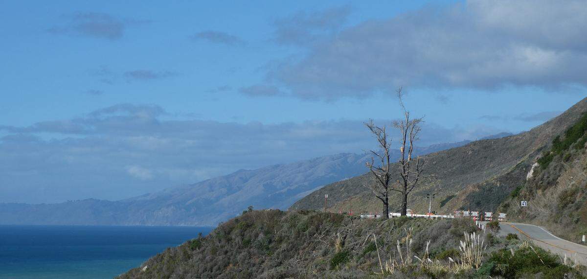 Those barely visible road barriers on Highway 1 about 2 miles north of Lucia in Monterey County are to be removed Wednesday, Jan. 14, three years to the day after the first of a cascade of slides closed a slide-prone section of the scenic highway between Cambria and Carmel. Caltrans has declared the road fully passable following repairs to a stubborn closure at Regent’s Slide, about 27 miles north of the San Luis Obispo/Monterey County line. The photo was taken by Christina Galloway, chairperson for the North Coast Advisory Council on Dec. 27, 2025.