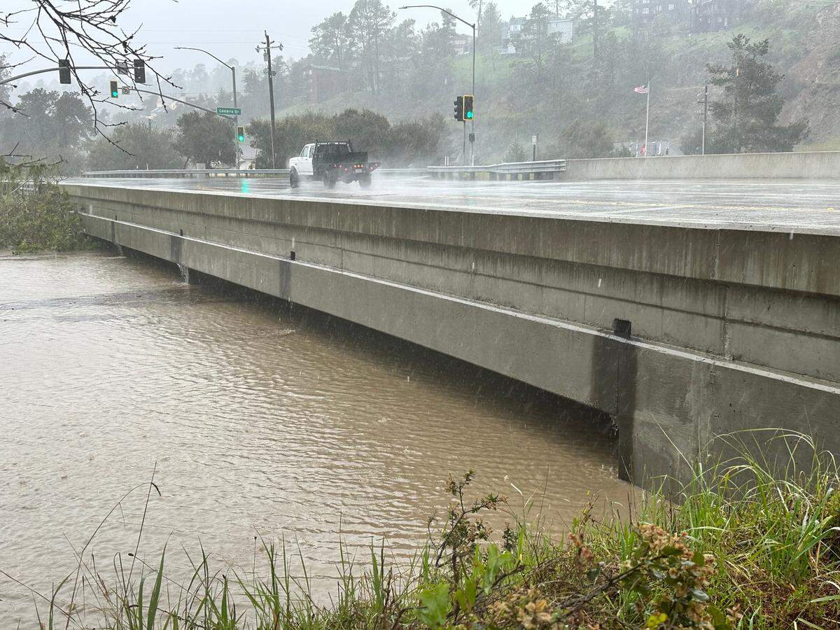Santa Rosa Creek water surging at high level under the Windsor Boulevard bridge that connects the residential Park Hill area with Highway 1 on March 10, 2023.