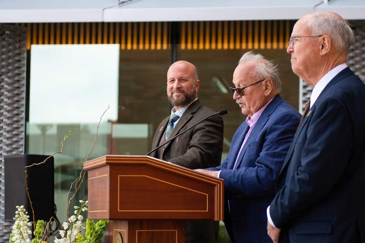 Dean Wendt, dean of Cal Poly’s Bailey College of Science and Mathematics, William Frost, center, and Phil Bailey speak to attendees at the dedication of the William and Linda Frost Center for Research and Innovation in May 2023.