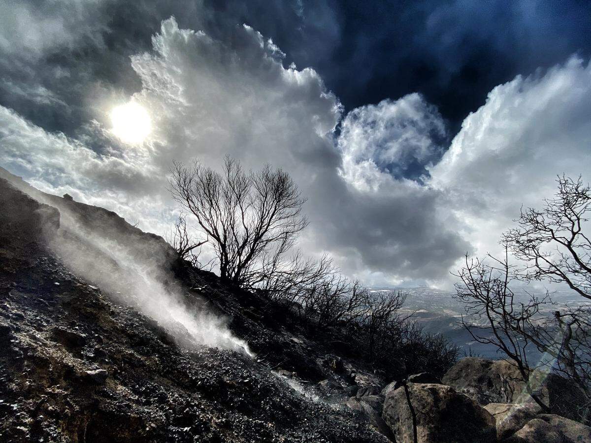 Smoldering spots still are present throughout the rain-soaked burn area, like this view atop East Camino Cielo Wednesday morning.