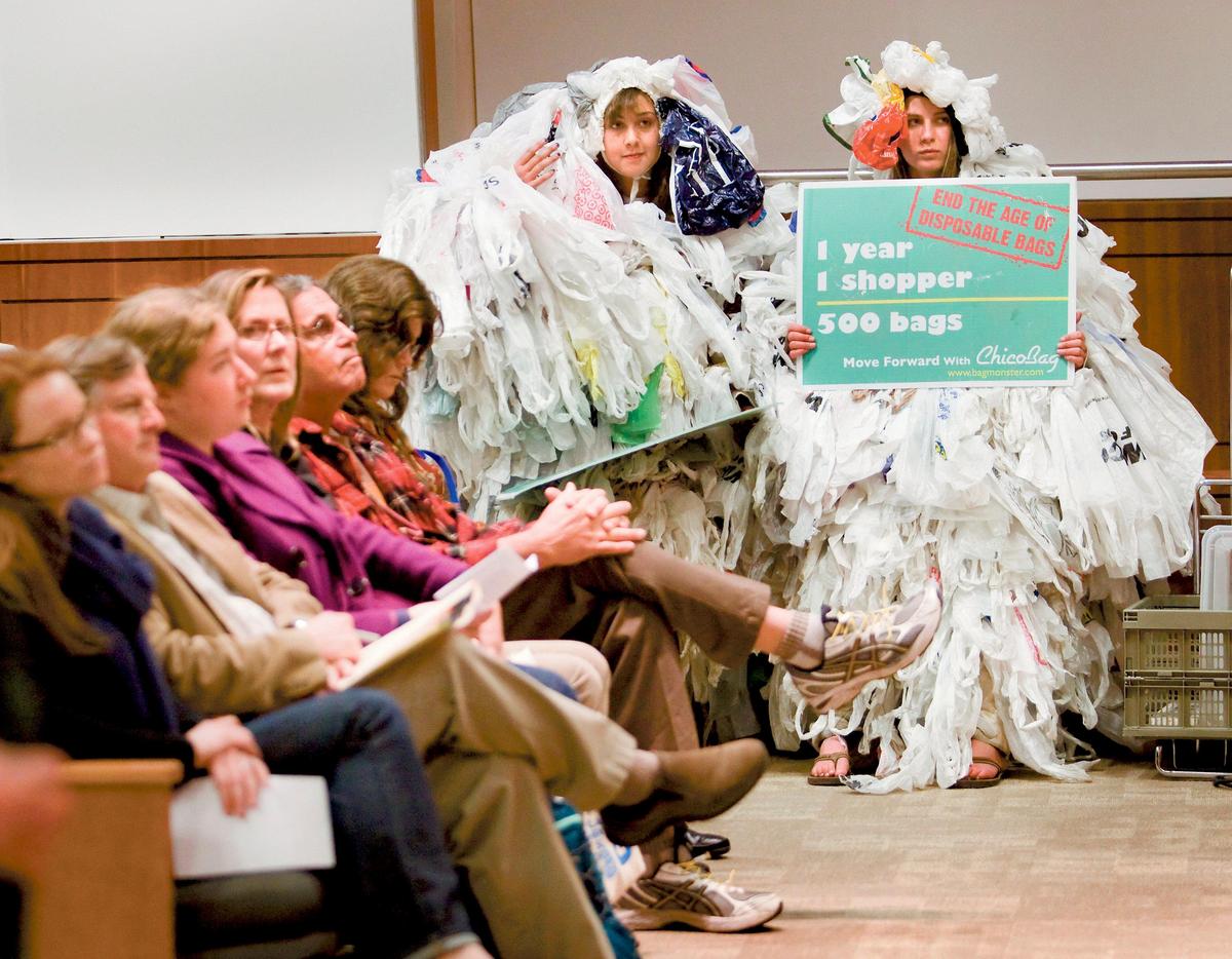 Emma Vogan, right, and Molliann Jones from the Arroyo Grande High School Surfrider Club sit covered head to toe in plastic bags for a chance to address the Integrated Waste Management board during a meeting to decide on whether or not to ban plastic bags from retail stores in 2012. 
