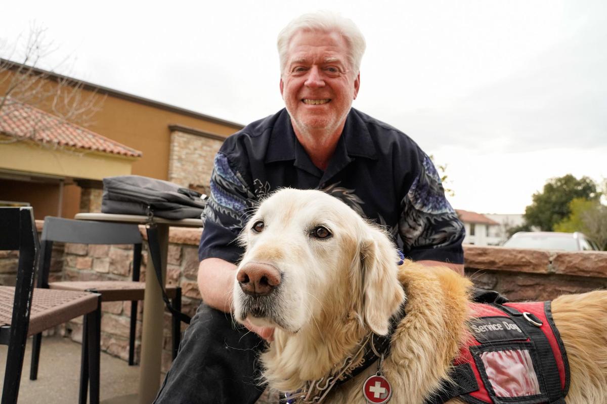 Transitions-Mental Health Association behavioral health navigator John Crippen and his service dog Ranger pose for a picture in Atascadero Friday, Jan. 31, 2025. Crippen’s job of checking in on clients living with mental and behavioral health issues is threatened by funding cuts caused by Prop 1.