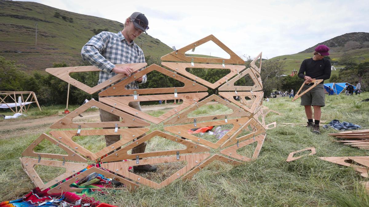 Eli Clifford at left and Rory Bruton of Cal Poly assemble their triangle based structure titled OGMI. Architecture students from throughout the west came to Poly Canyon participate in Design Village on the Cal Poly campus on April 25, 2025.