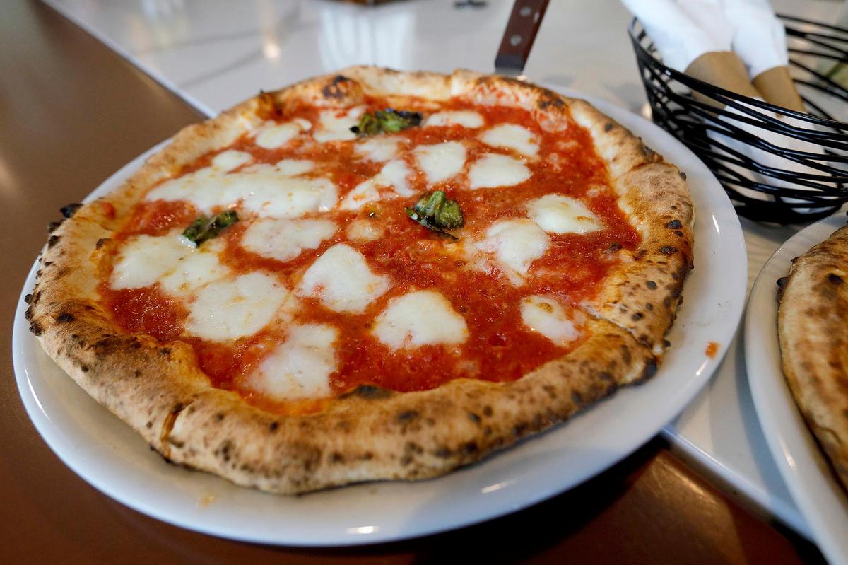 The Margherita D.O.P con Bufala is made with San Marzano DOP tomatoes, fresh mozzarella di Bufala, basic, pecorino romano and Ligurian DOP EVOO.