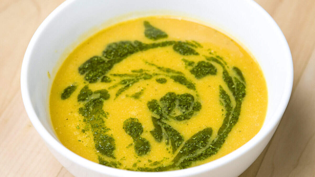 Chef Dave Schmit serves roasted butternut squash soup with cilantro herb pesto.