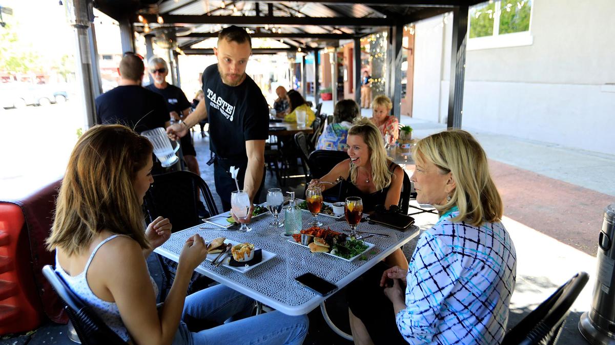 Diners eat outside at a parklet in front of Taste on 11th Street in Paso Robles in October 2021. The city ended its temporary parklet program in November 2021 and is now discussing whether to create a permanent program of some kind.