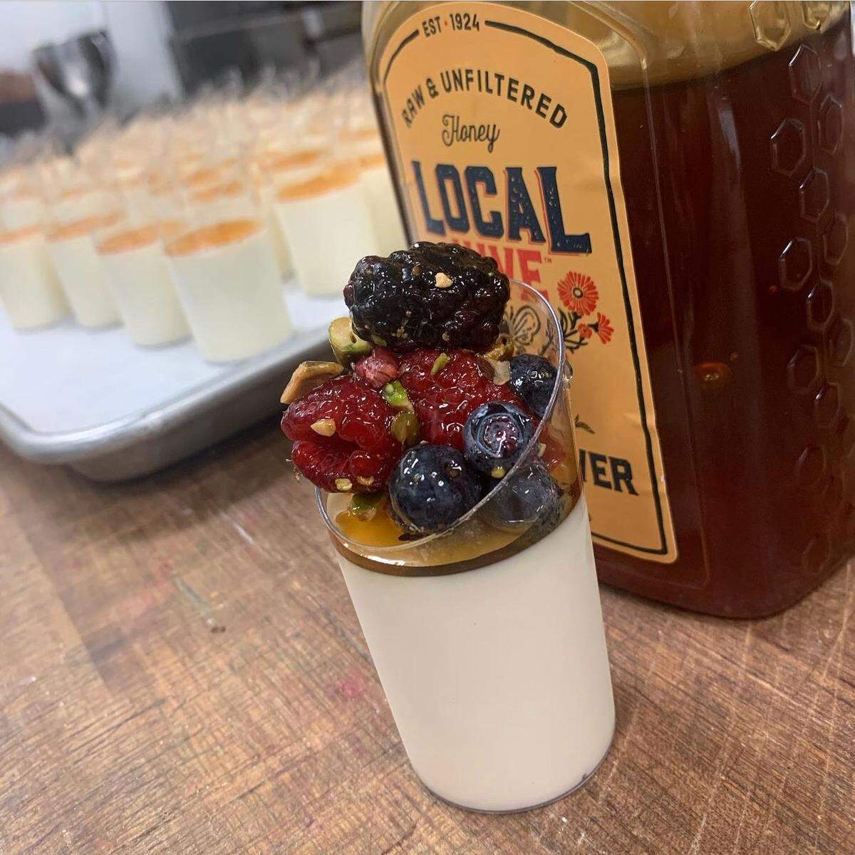 Pardon My French Bakery in Grover Beach served panna cotta in a glass topped with berries, pistachios and honey at a recent wedding.