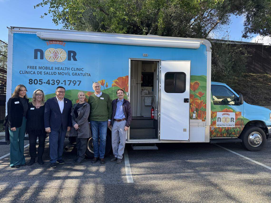 Rep. Salud Carbajal poses for a photo with SLO Noor Foundation leaders on Feb. 18, 2026. The foundation has a San Luis Obispo-based medical center and a mobile medical clinic, pictured in the background, to treat uninsured residents.