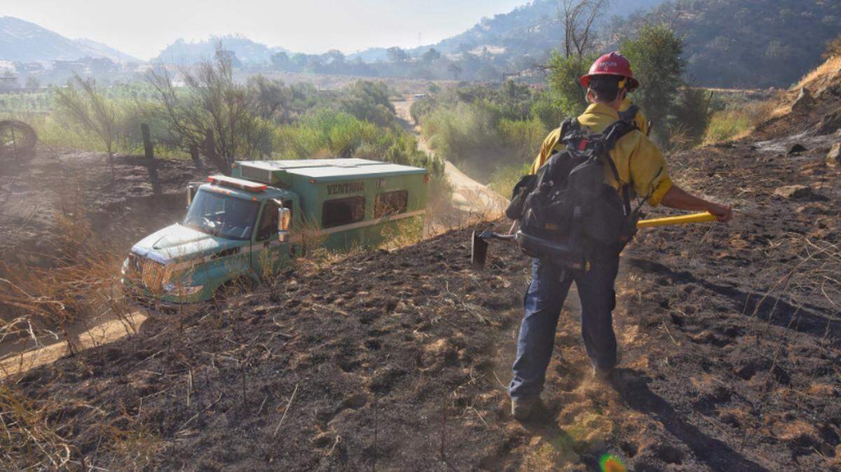 Firefighters from Los Padres National Forest and Santa Barbara County Fire Department, shown here, are among the personnel assigned to the Front Fire burning east of Santa Maria Monday.