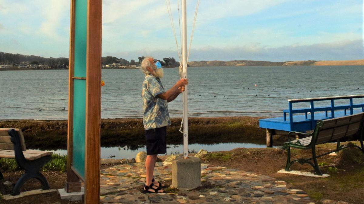 George Brown raises the small-craft advisory flag on Saturday, Feb. 13, 2021, at Baywood Park.