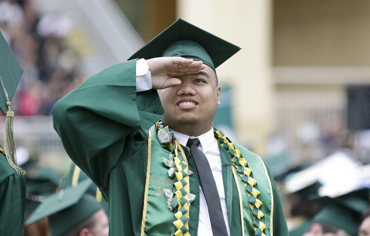 Dan Le, a kinesiology major, searches for his family in the stands during the Cal Poly graduation commencement ceremony for College of Agriculture, Food and Environmental Sciences and College of Science and Mathematics Saturday, June 16, 2018.