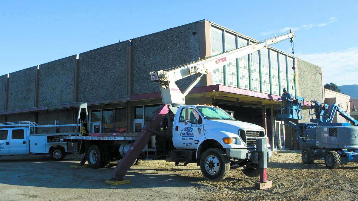 Welders from J&D Welding work on an awning at the University Square shopping center. Construction began about three months ago on the project.