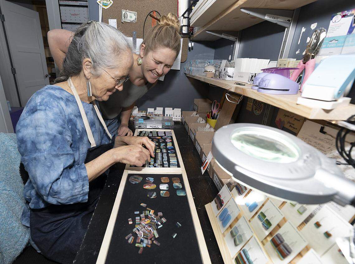 Surf Gems founder Abby Ahlgrim and her mother, Jennifer Nori, pack up jewelry made out of resin leftover from surfboard production.