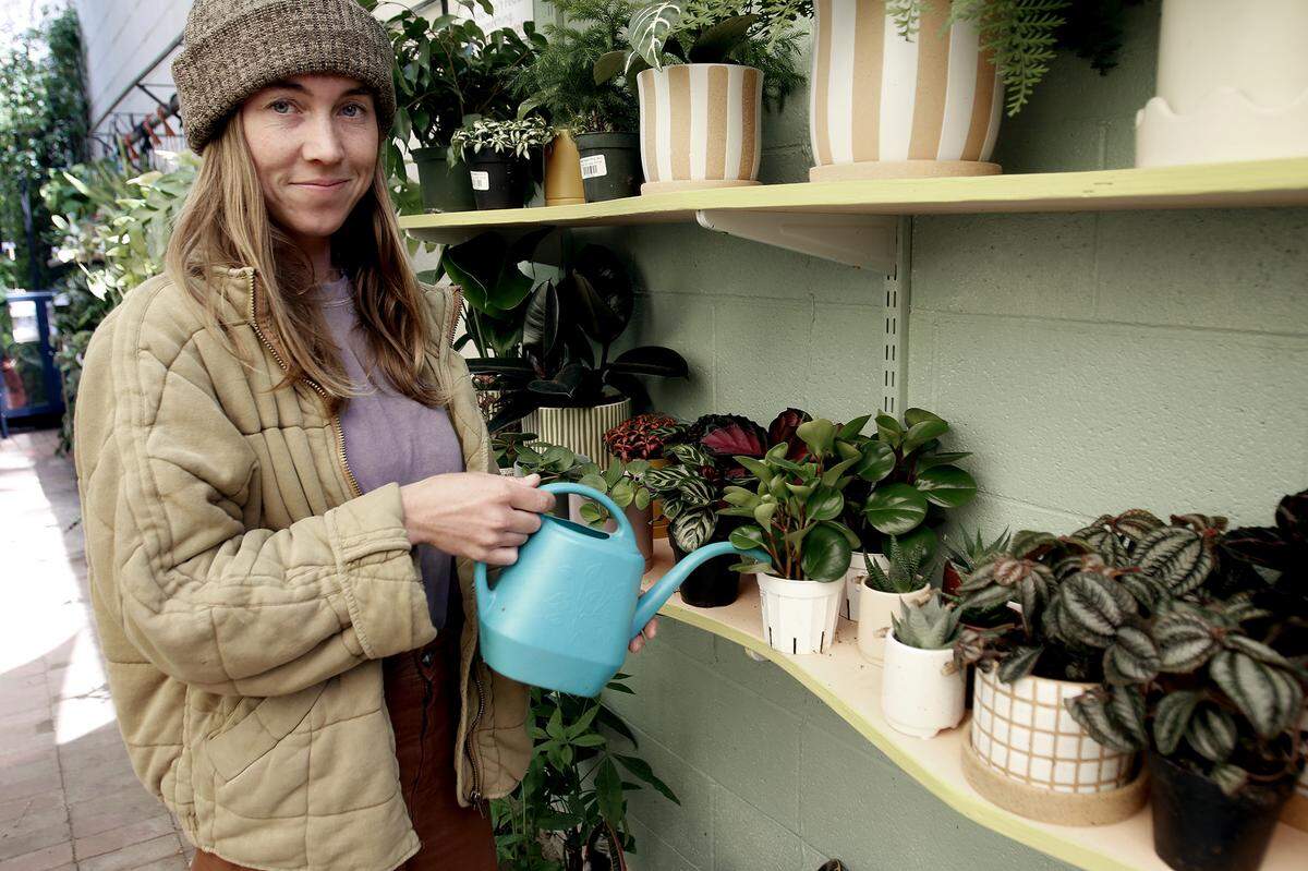Owner Samantha Huntley waters a plant in her outdoor store. Understory Plant Shop opened in downtown San Luis Obispo, California as part of Huntley’s interior plant design business Happy Plant Company.
