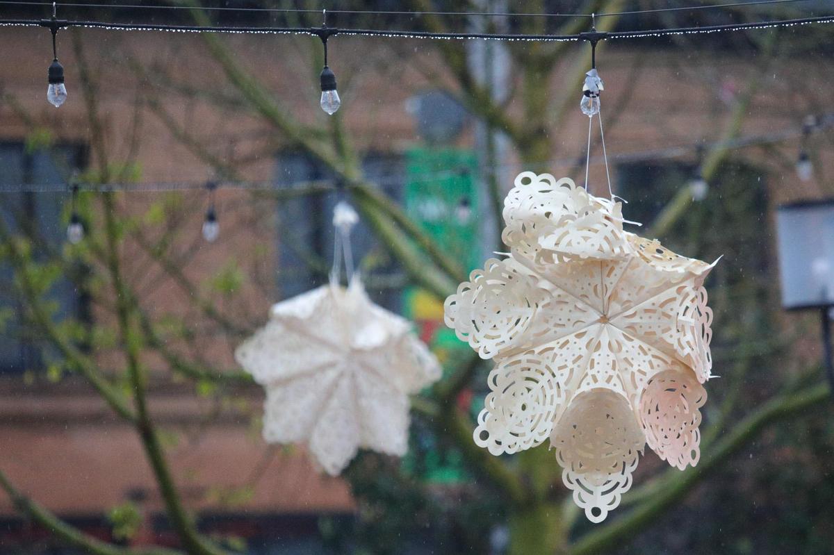 Bedraggled paper snowflakes have been battered by wind and rain at Mission Plaza. The rain continued to fall in downtown San Luis Obispo on Tuesday, Dec. 14, 2021.