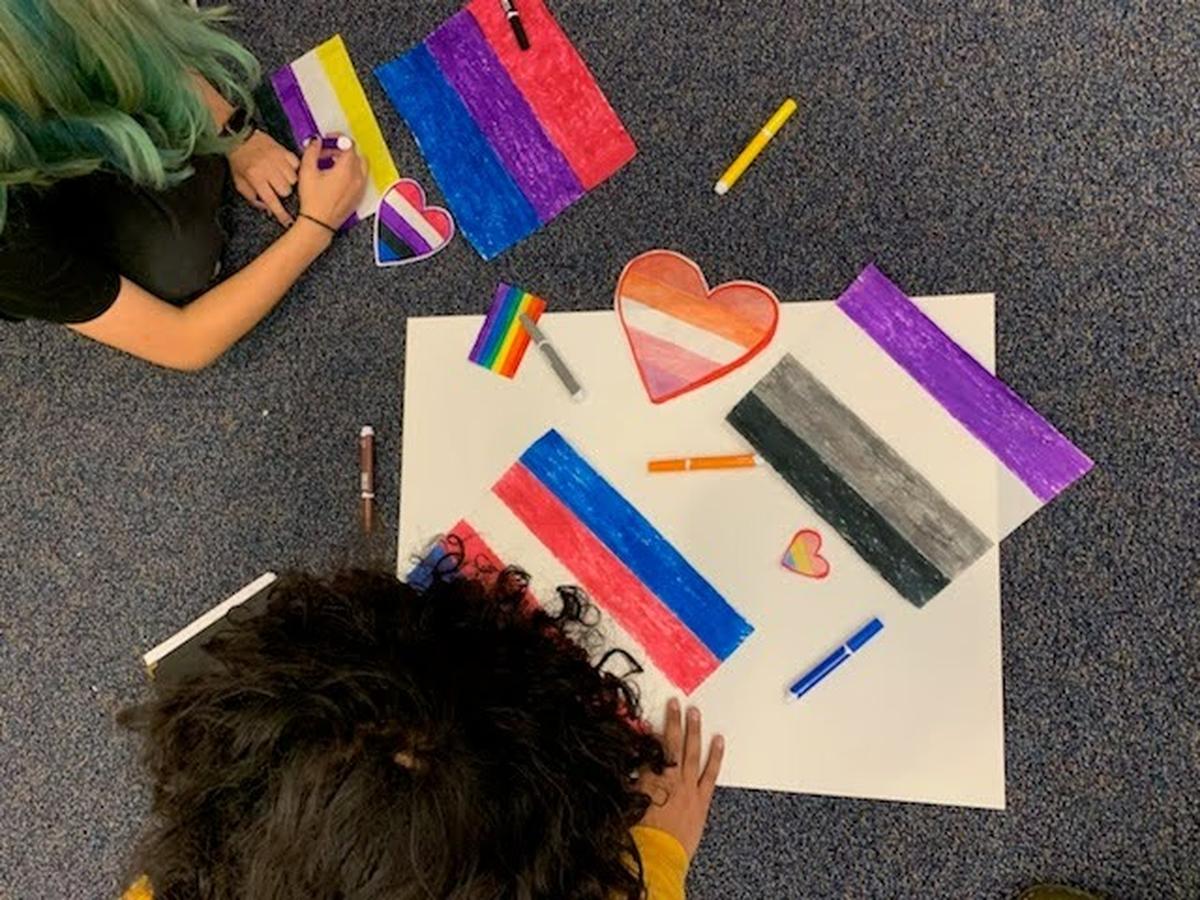 Students at Paso Robles High School create signs promoting love and inclusion after an incident in which an LGBTQ Pride flag was stolen from a classroom and defecated on. Following the incident, the district changed its policy to limit the size of flag displays.