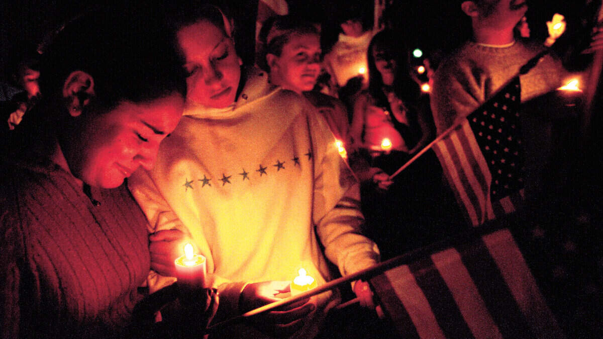 Alita Boyle, 17, and Ashley Shurick, 17, reflect on the Sept. 11th attack at a  candlelight vigil in Arroyo Grande in 2001. Photo by Jayson Mellom