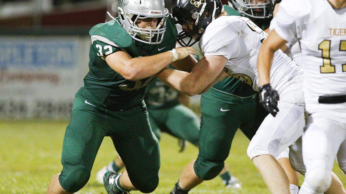 Templeton High player Isaac Lindsey, left, tries to get around San Luis Obispo's Ryan Clayton during Friday's high school football game.
